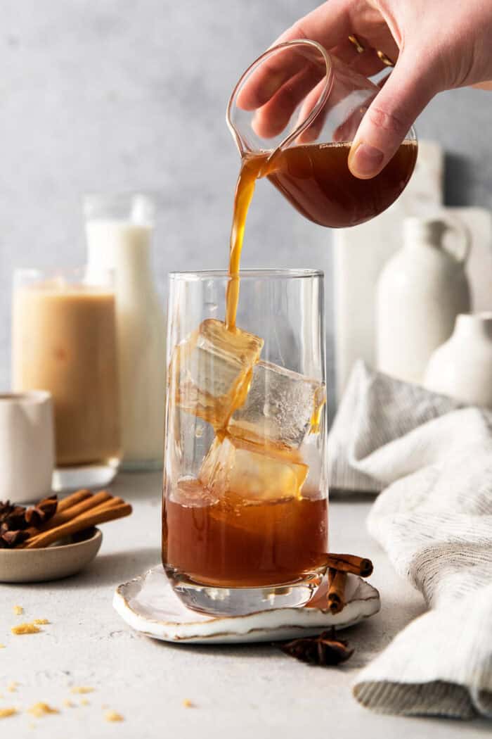 Chai concentrate is poured into a glass wtih ice.