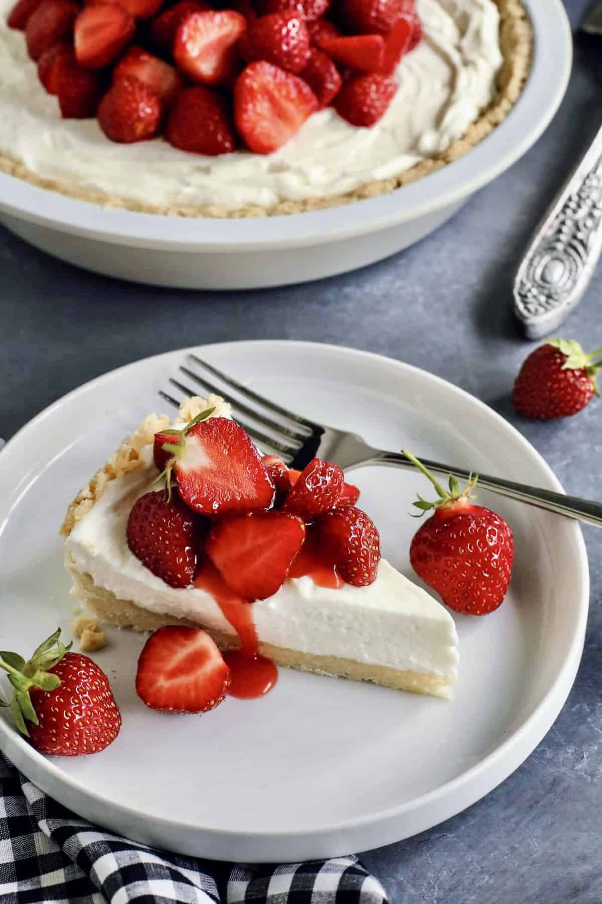 a piece of strawberry cream cheese pie on a white plate