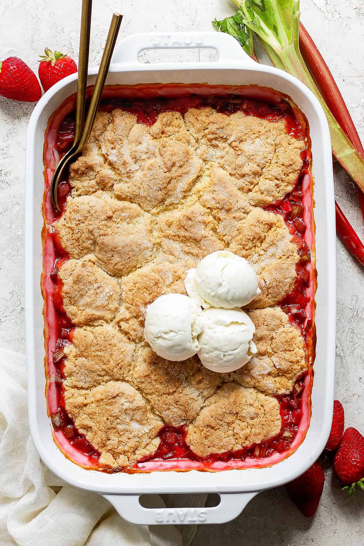 baked rhubarb strawberry cobbler in a white rectangular baking dish