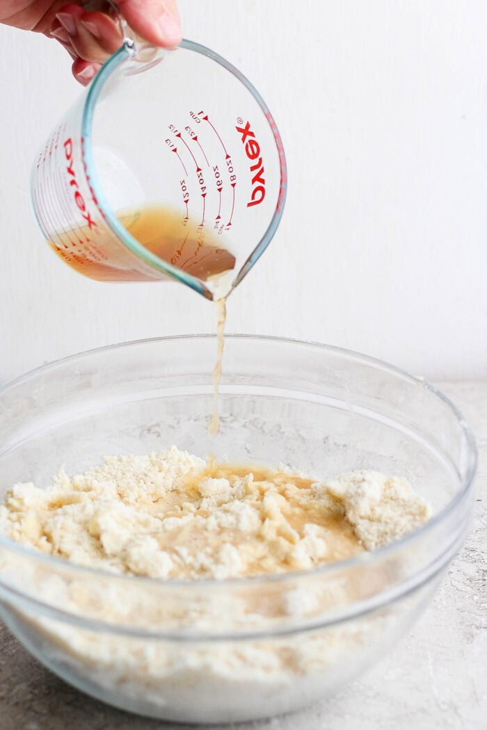 pouring hot water and vanilla over the dry cobbler ingredients