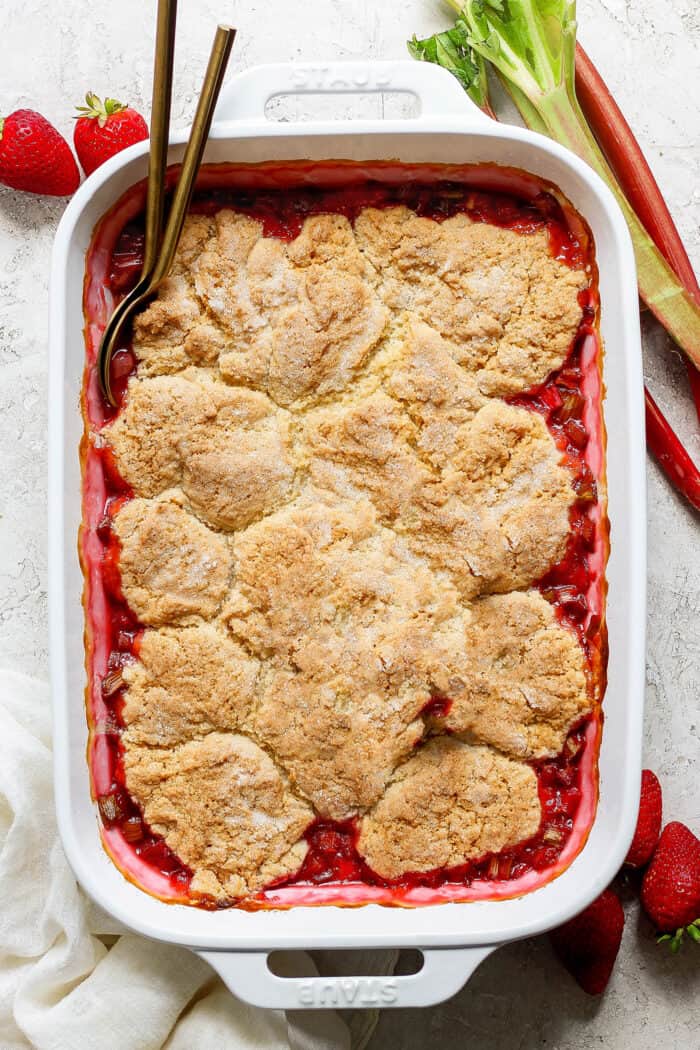 overhead photo of top of baked cobbler with strawberries and rhubarb