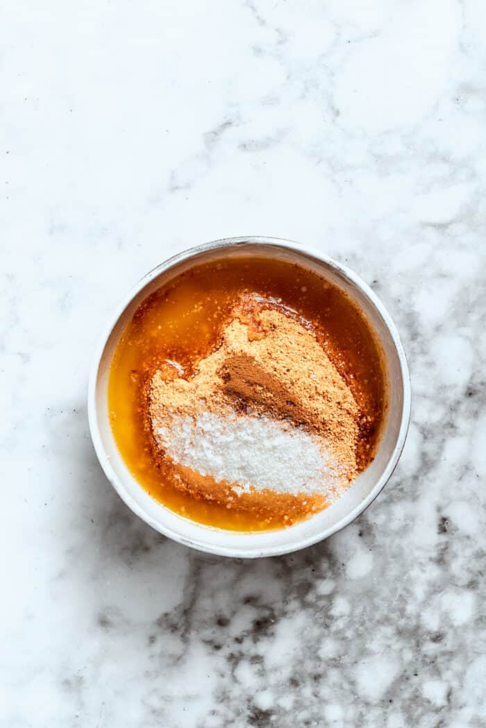 Graham cracker crust ingredients are mixed in a bowl.