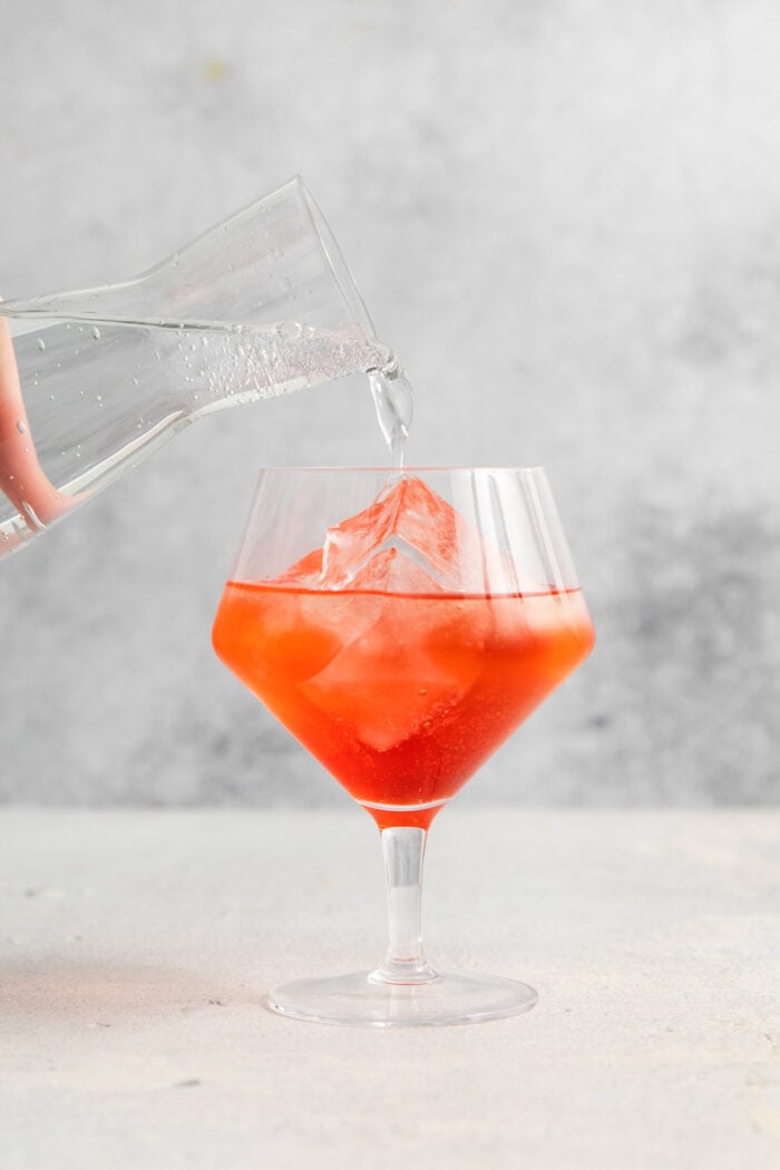The glass is topped off with club soda.