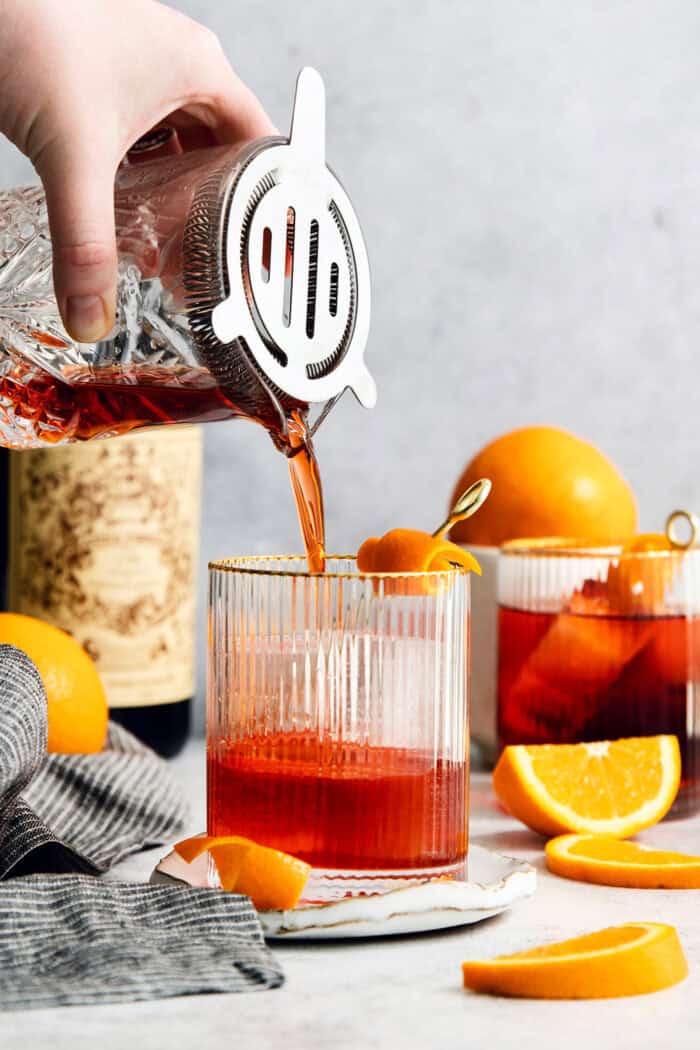 The Negroni is strained into a glass.