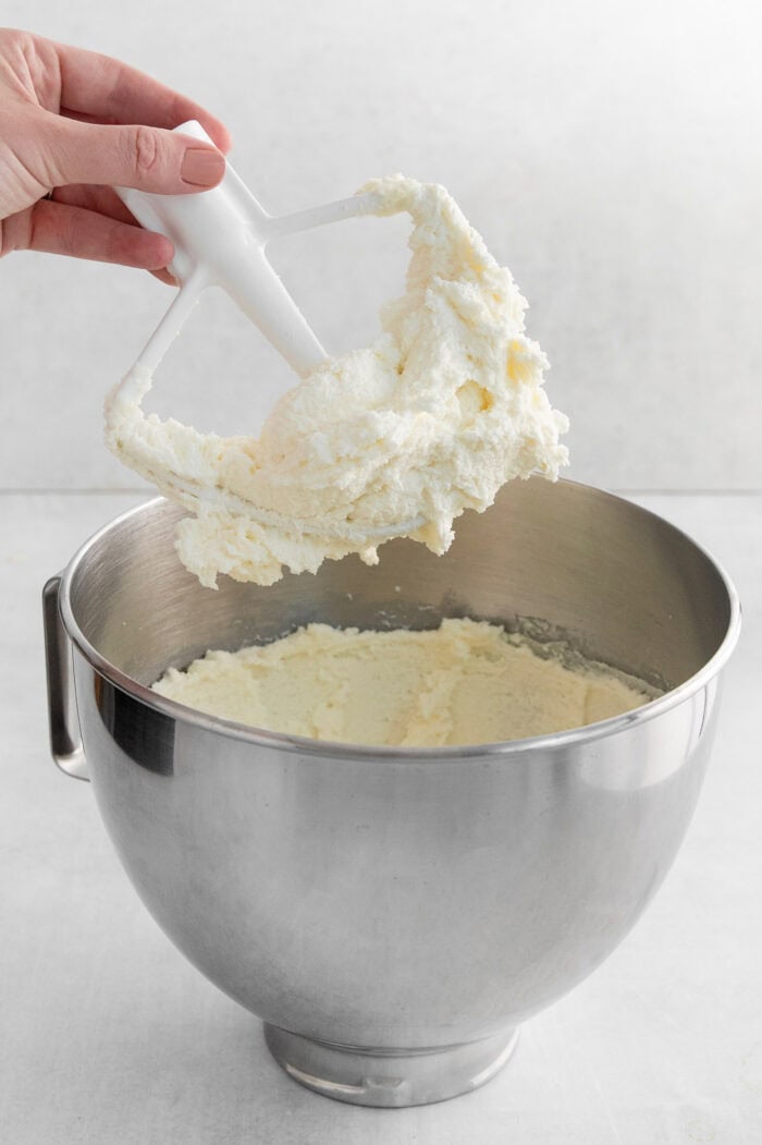 Butter and sugar are creamed in a mixer.