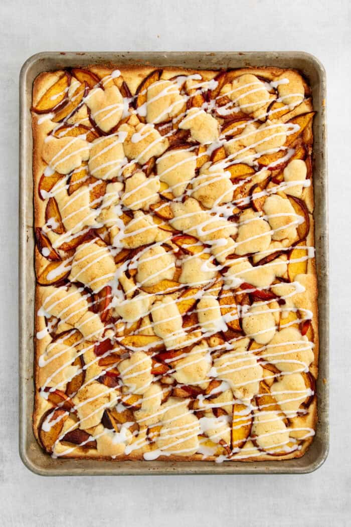 The peach bars are shown topped with glaze in the pan.
