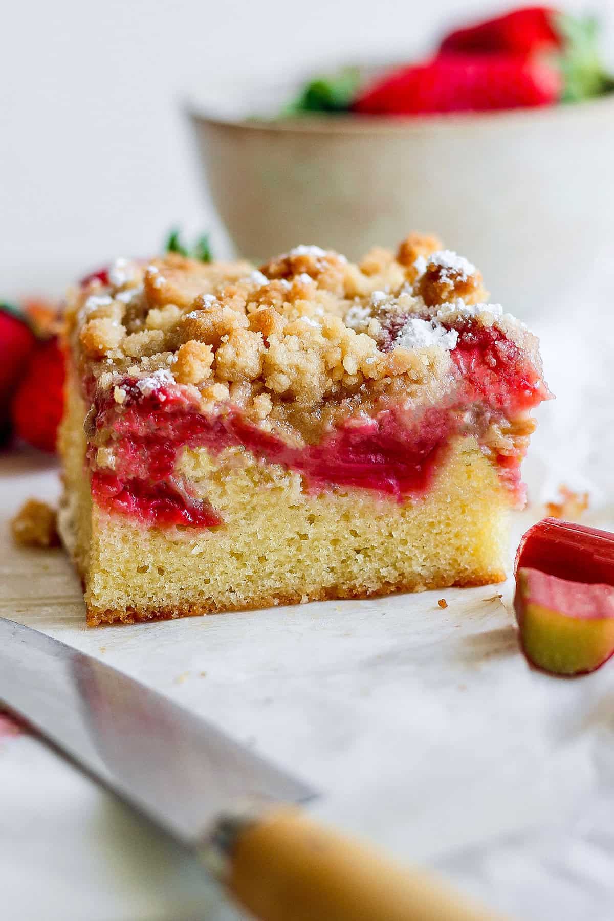 side view of a strawberry rhubarb bar with crumb topping