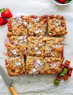 strawberry rhubarb bars on a piece of parchment paper