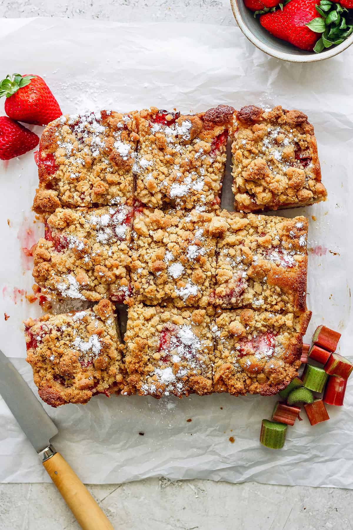 strawberry rhubarb bars on a piece of parchment paper