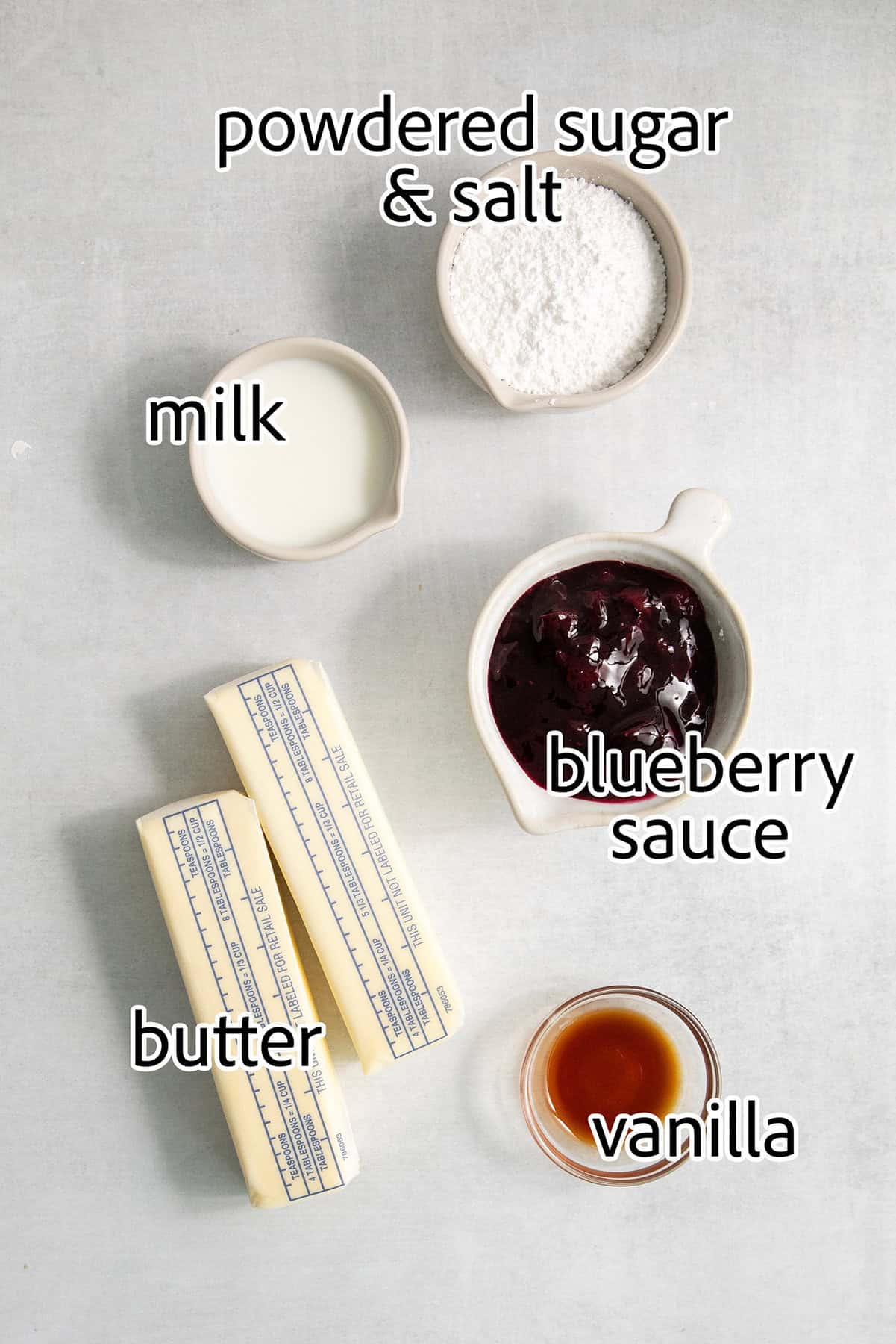 Ingredients for blueberry butter: powdered sugar, milk, vanilla, blueberry sauce, butter.