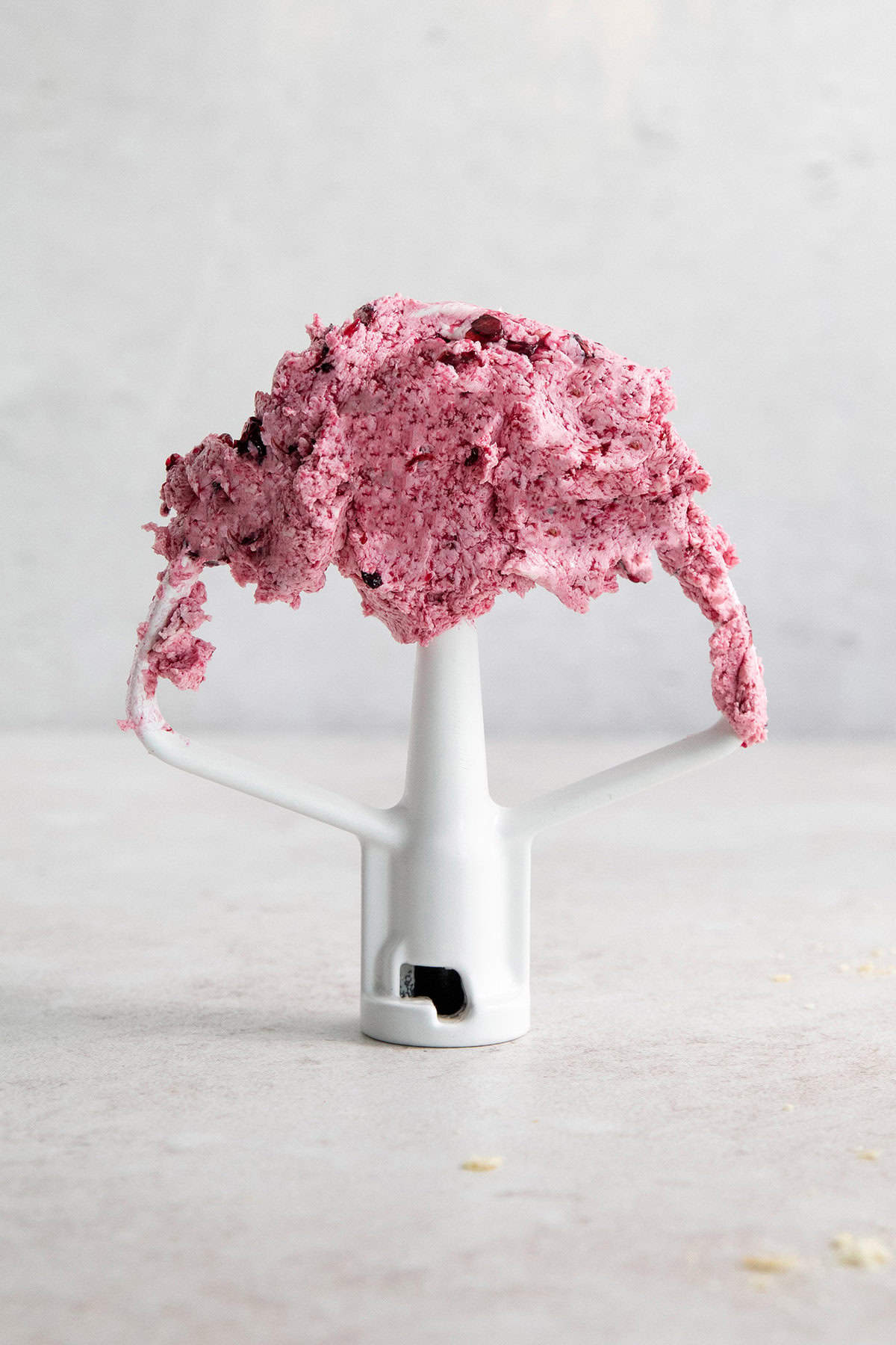 Blueberry butter on the attachment of a stand mixer.