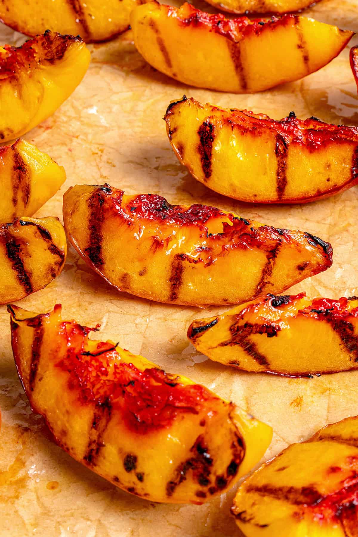 Slightly charred slices of grilled peach.