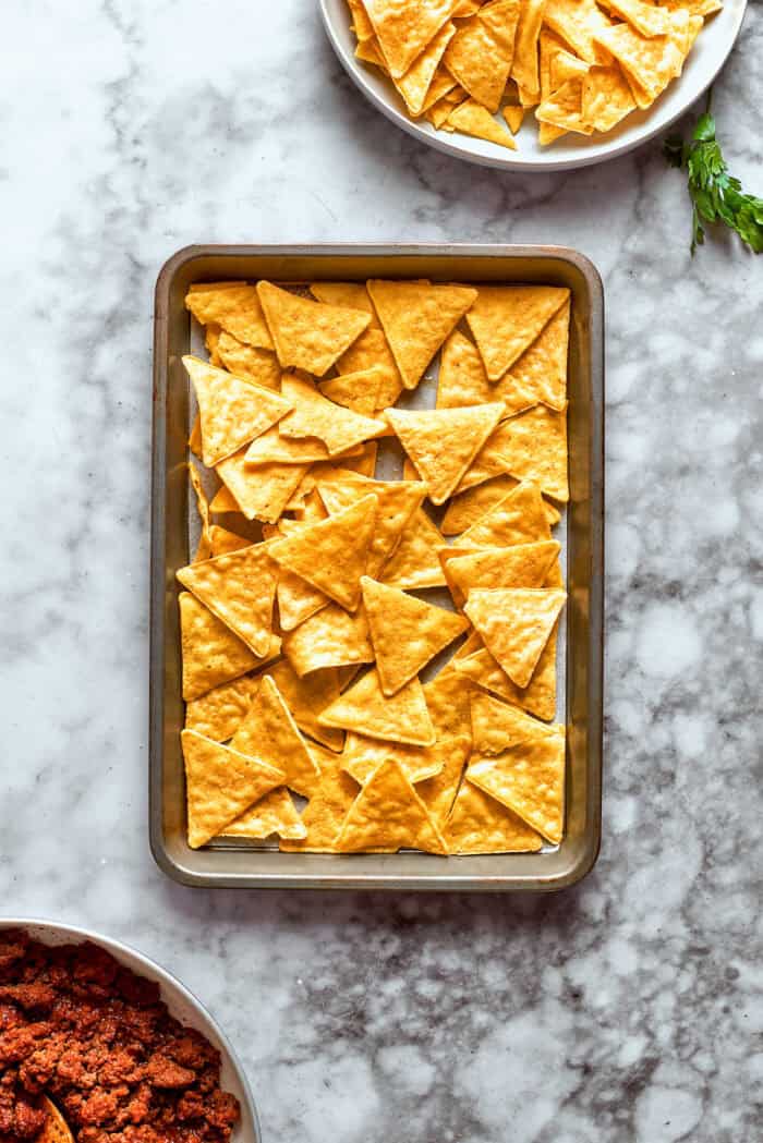 Chips are added to a sheet pan.