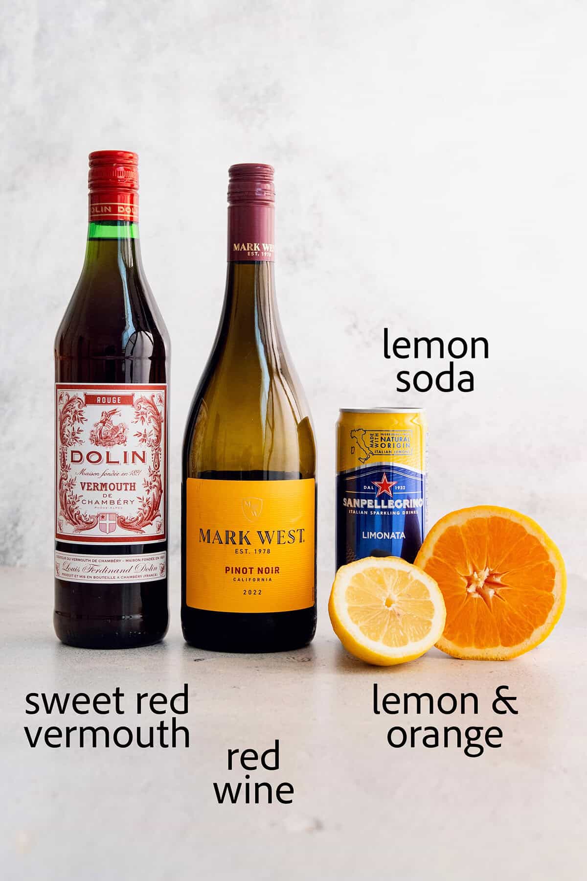 Ingredients for tinto de verano: sweet vermouth, red wine, lemon soda, lemon and oranges.