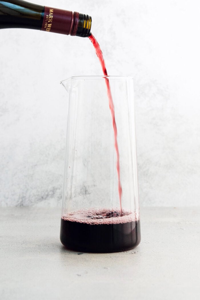 Red wine is poured into the pitchers.