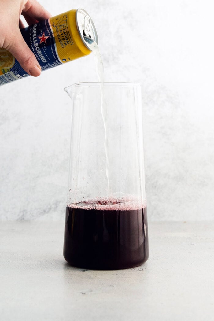 Lemon soda is added to the pitcher.