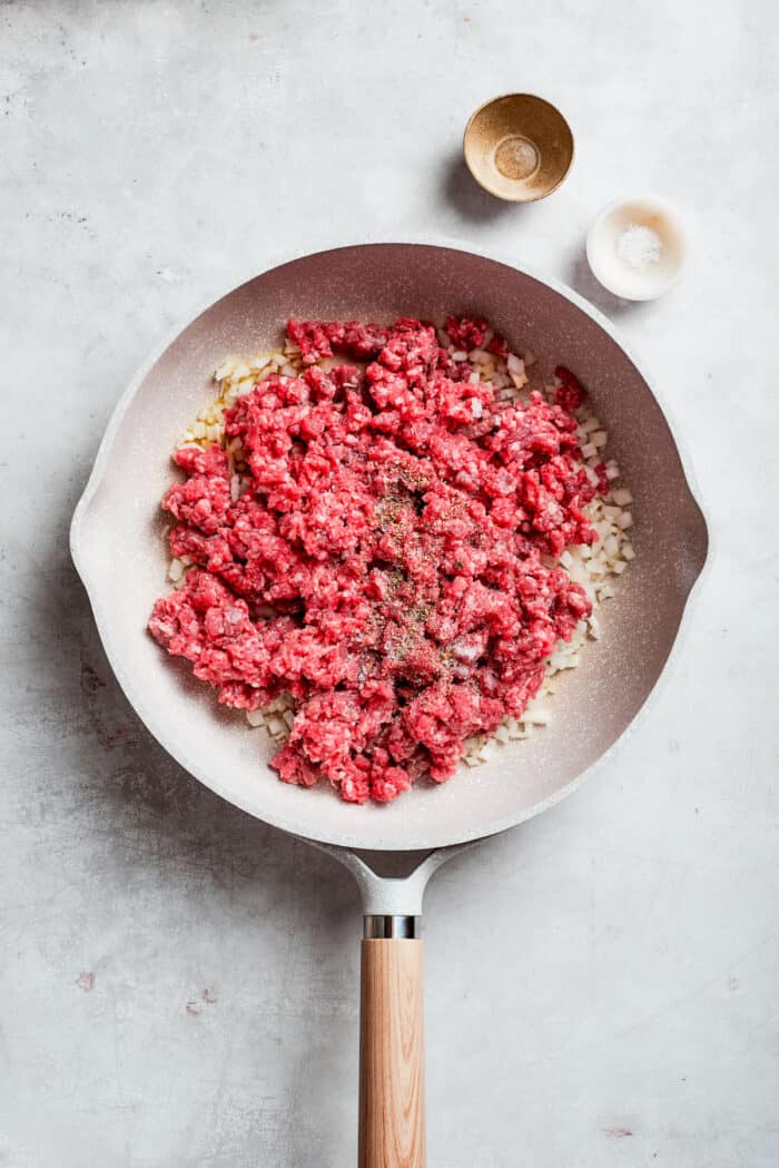 Ground beef is added to a skillet.