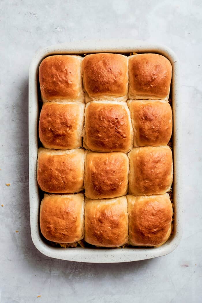 A pan of baked cheeseburger sliders.