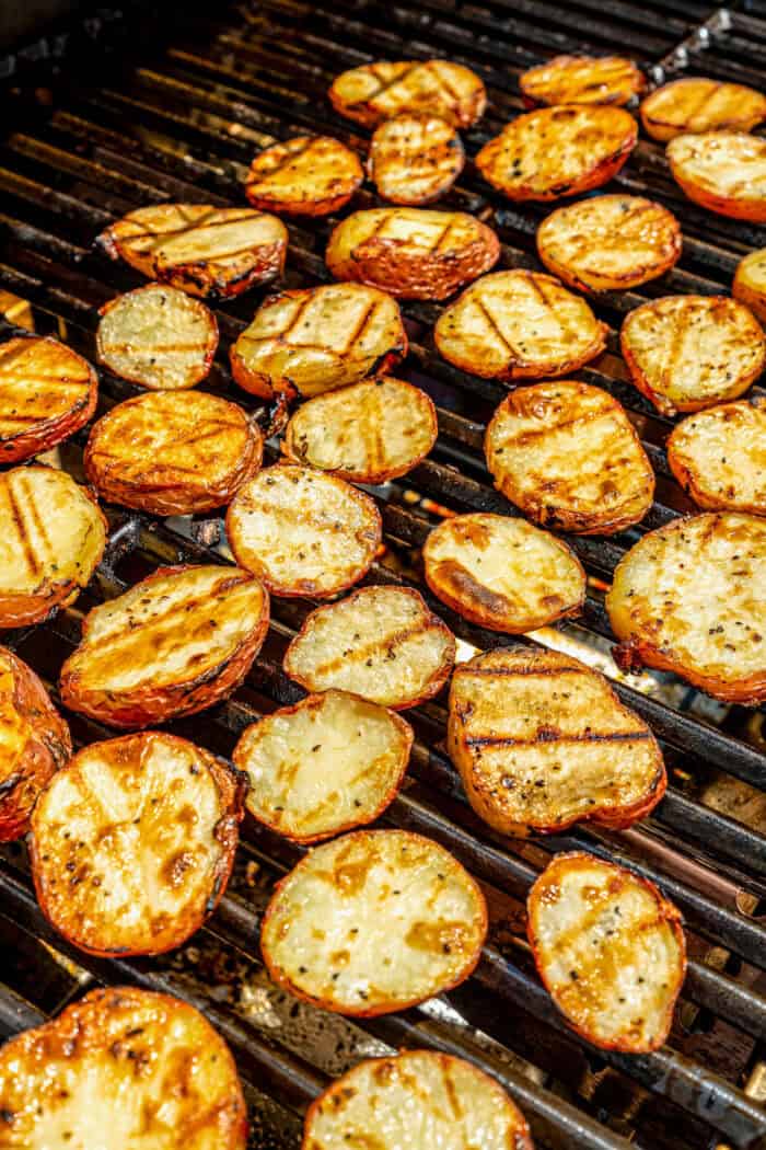 The red potatoes are added to the grill.
