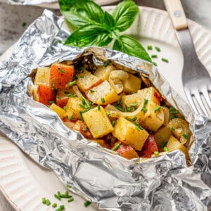 an opened foil packet of grilled potatoes