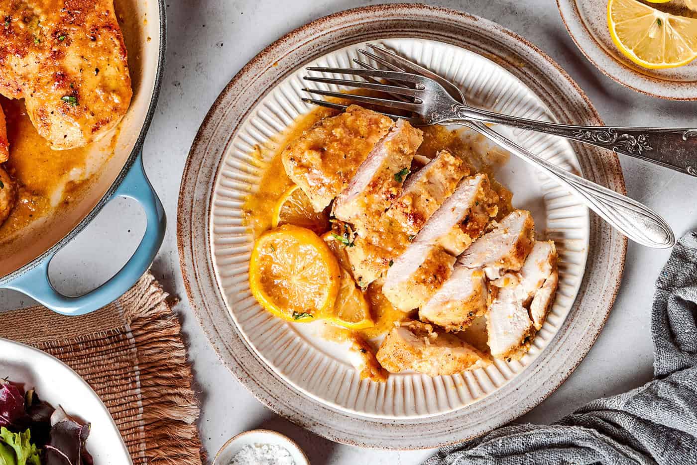 a sliced chicken breast with lemon and pepper, on a plate