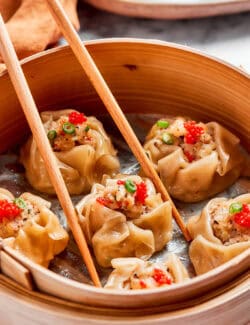shrimp shumai dumplings in a bamboo steamer basket