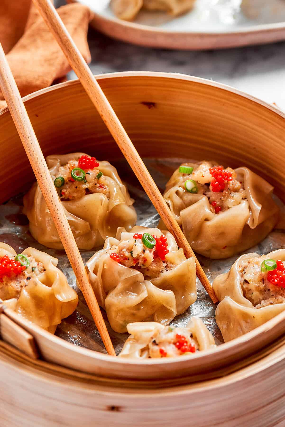 shrimp shumai dumplings in a bamboo steamer basket