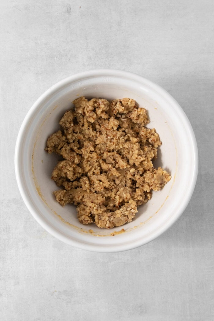 The crumbly pecan crust mixture in a bowl.