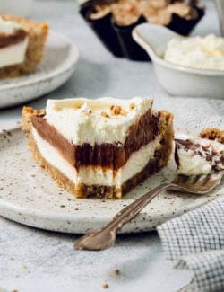 A slice of layered possum pie with whipped cream on top.