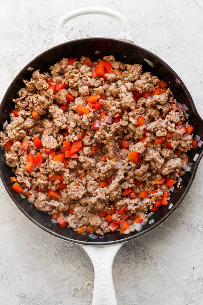Browned sausage and veggies in the skillet. 