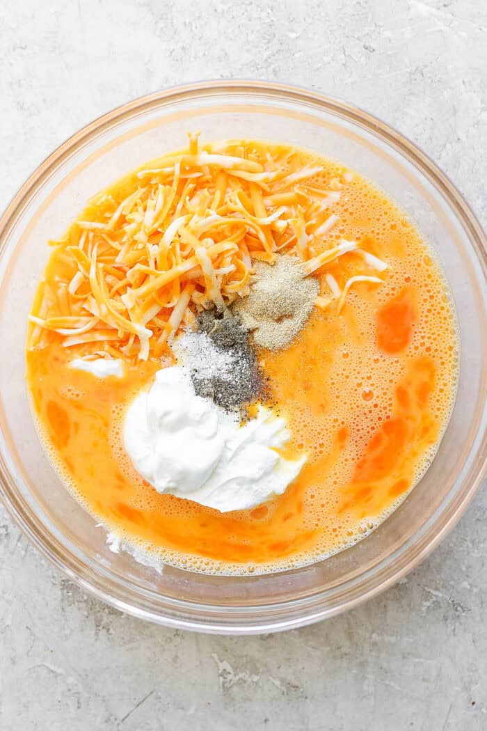 Adding the egg-mixture ingredients to a bowl for mixing.