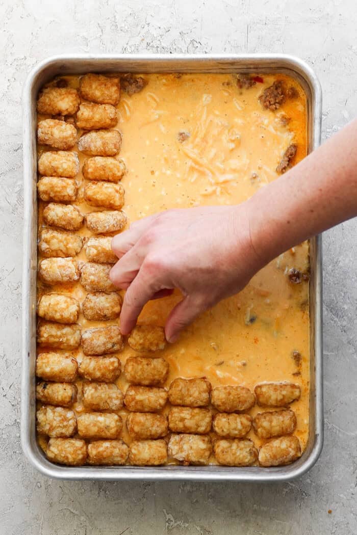 Adding the layer of frozen tater tots on top. 