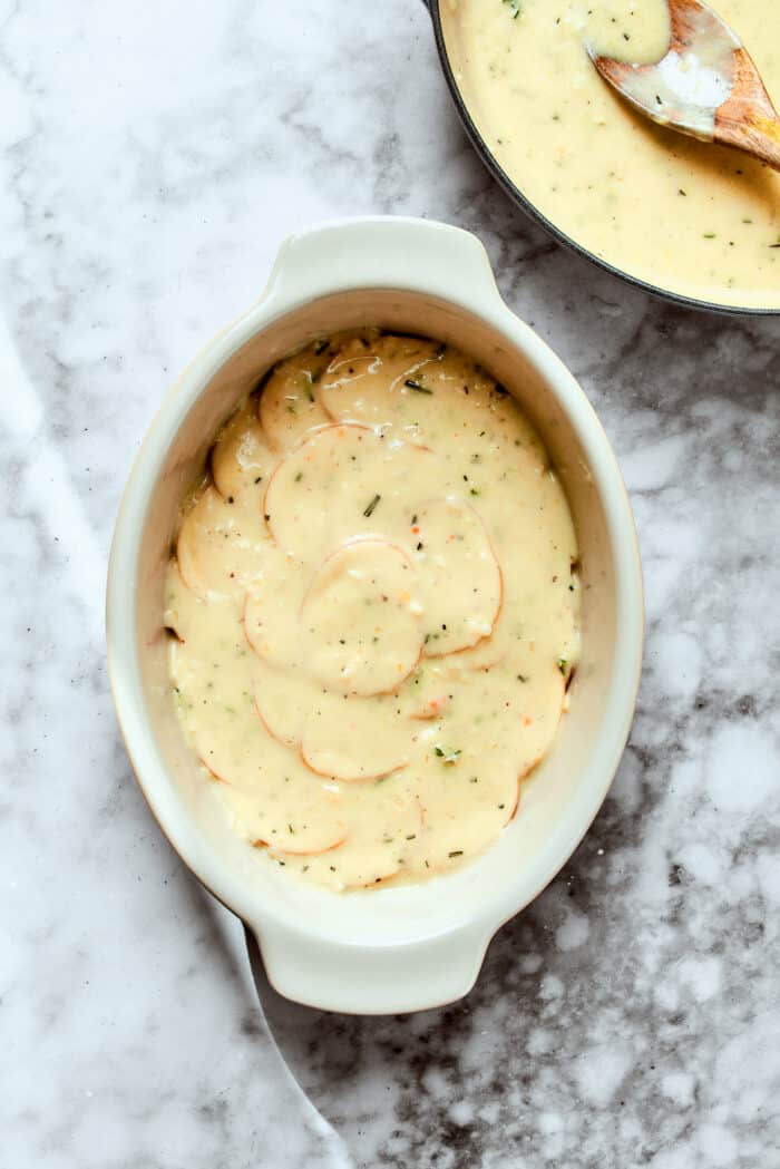 Layering the potatoes in the baking dish. 