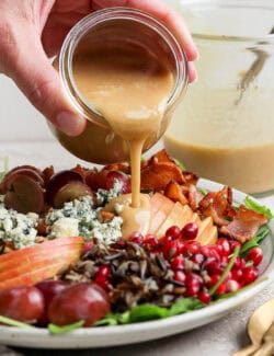 Pouring the dressing over holiday wild rice salad.