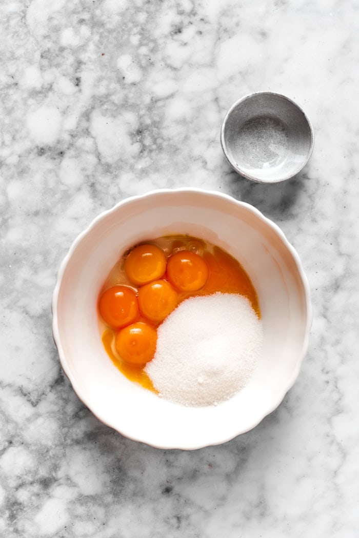 eggs and sugar in a white bowl