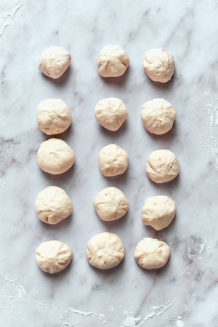 Raw pizza bites on marble work surface