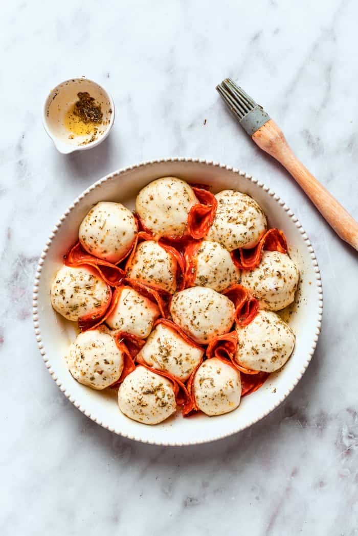 Pizza bites after brushing with herb oil