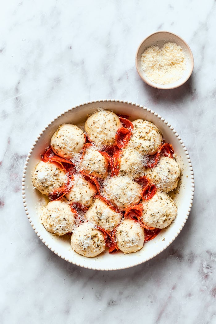Pizza bites in baking dish before baking