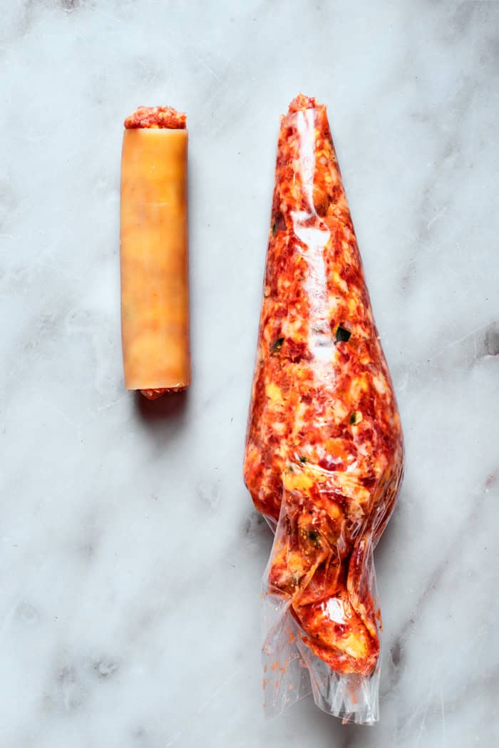 Piping bag set next to filled shotgun shell
