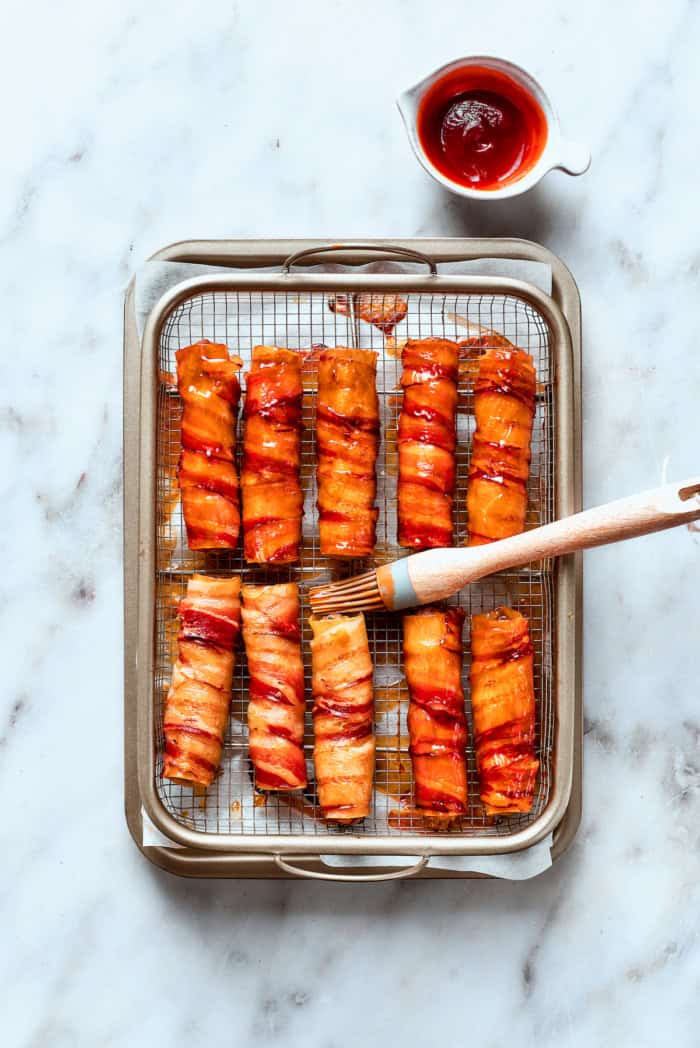 Brushing barbecue sauce onto oven-baked shotgun shells
