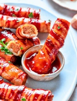 Dipping baked shotgun shell into barbecue sauce