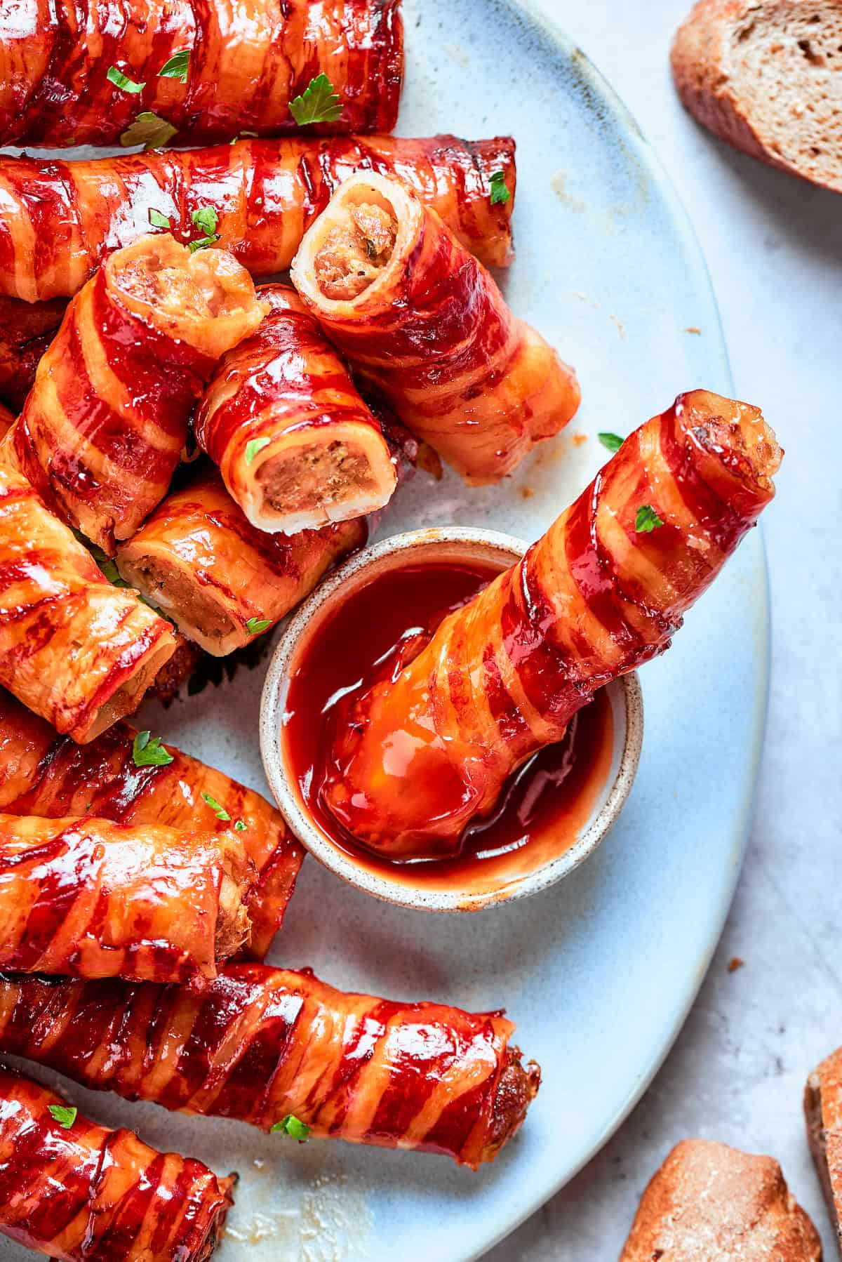 Dipping baked shotgun shell into barbecue sauce