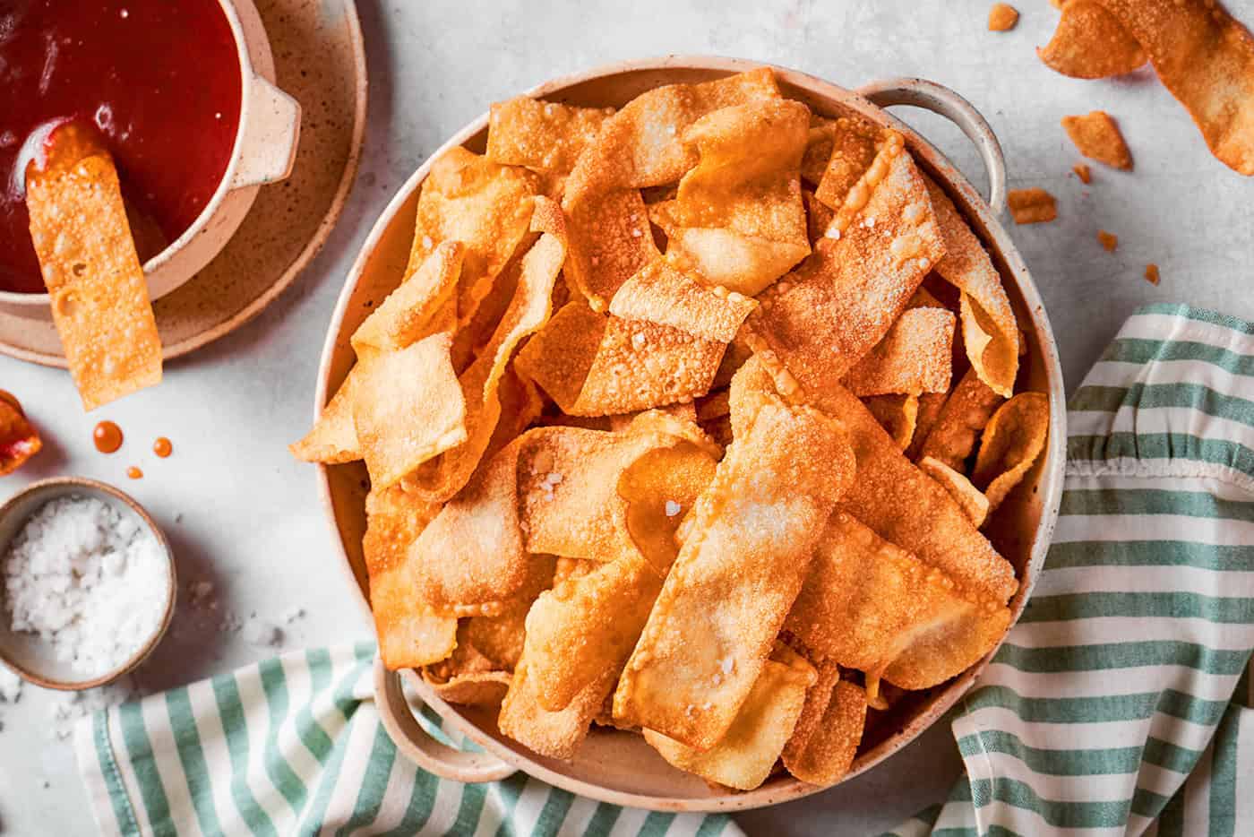 a bowl of homemade wonton chips with dipping sauce