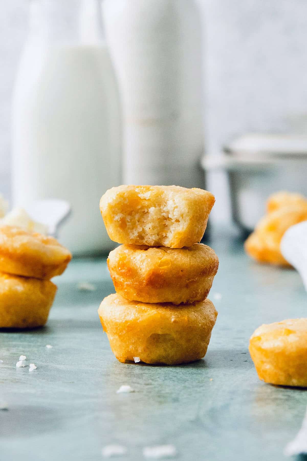 Stack of 3 pandebono, with top one bitten into to show texture inside