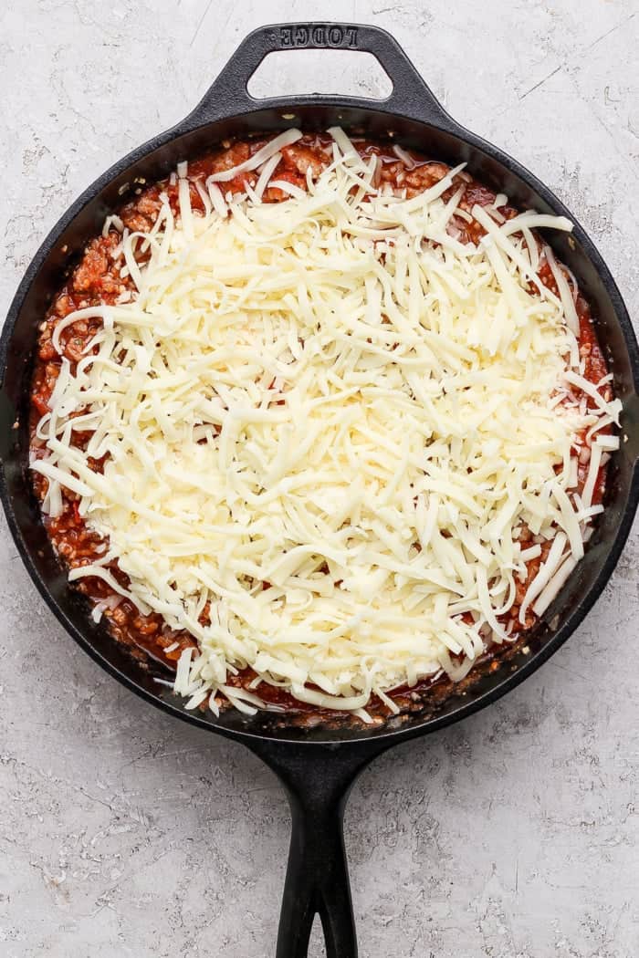 Mozzarella added to lasagna dip in skillet