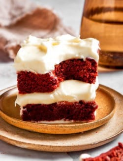 two red velvet brownies stacked on top of each other, on a plate