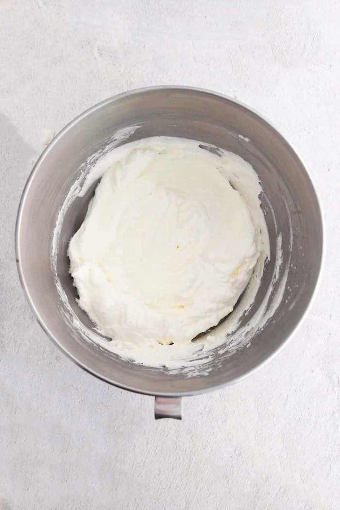 whipped cream in a stainless steel mixing bowl