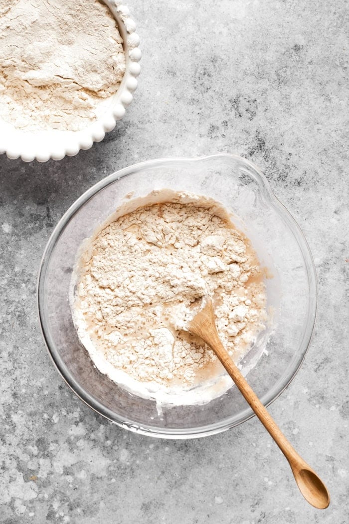 Stirring flour into liquid ingredients for dough