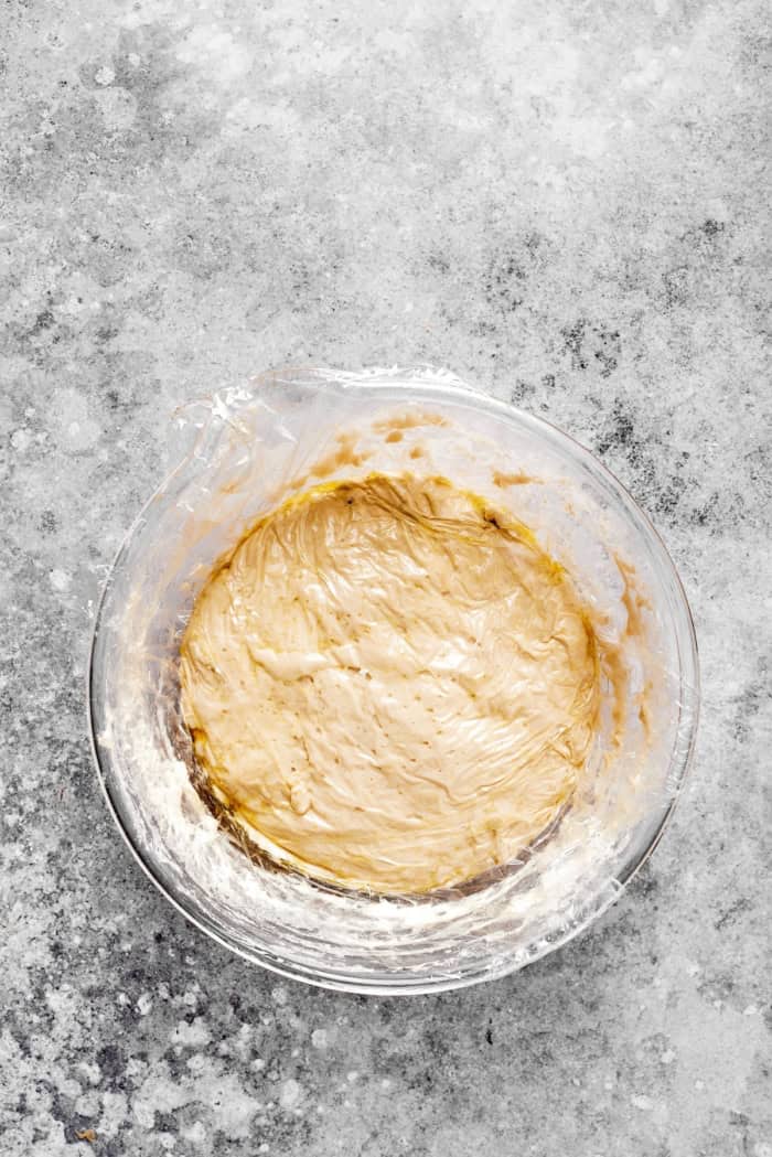 Overhead view of English muffin bread dough in bowl before rising