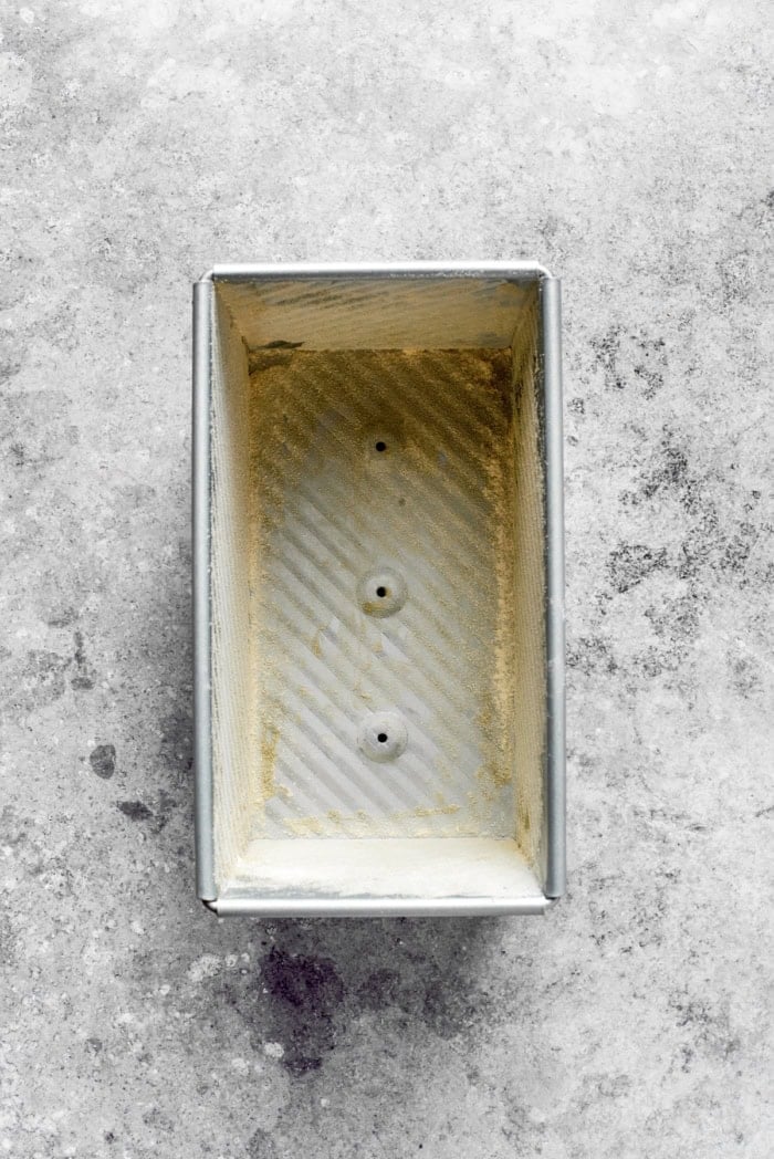 Overhead view of loaf pan dusted with cornmeal